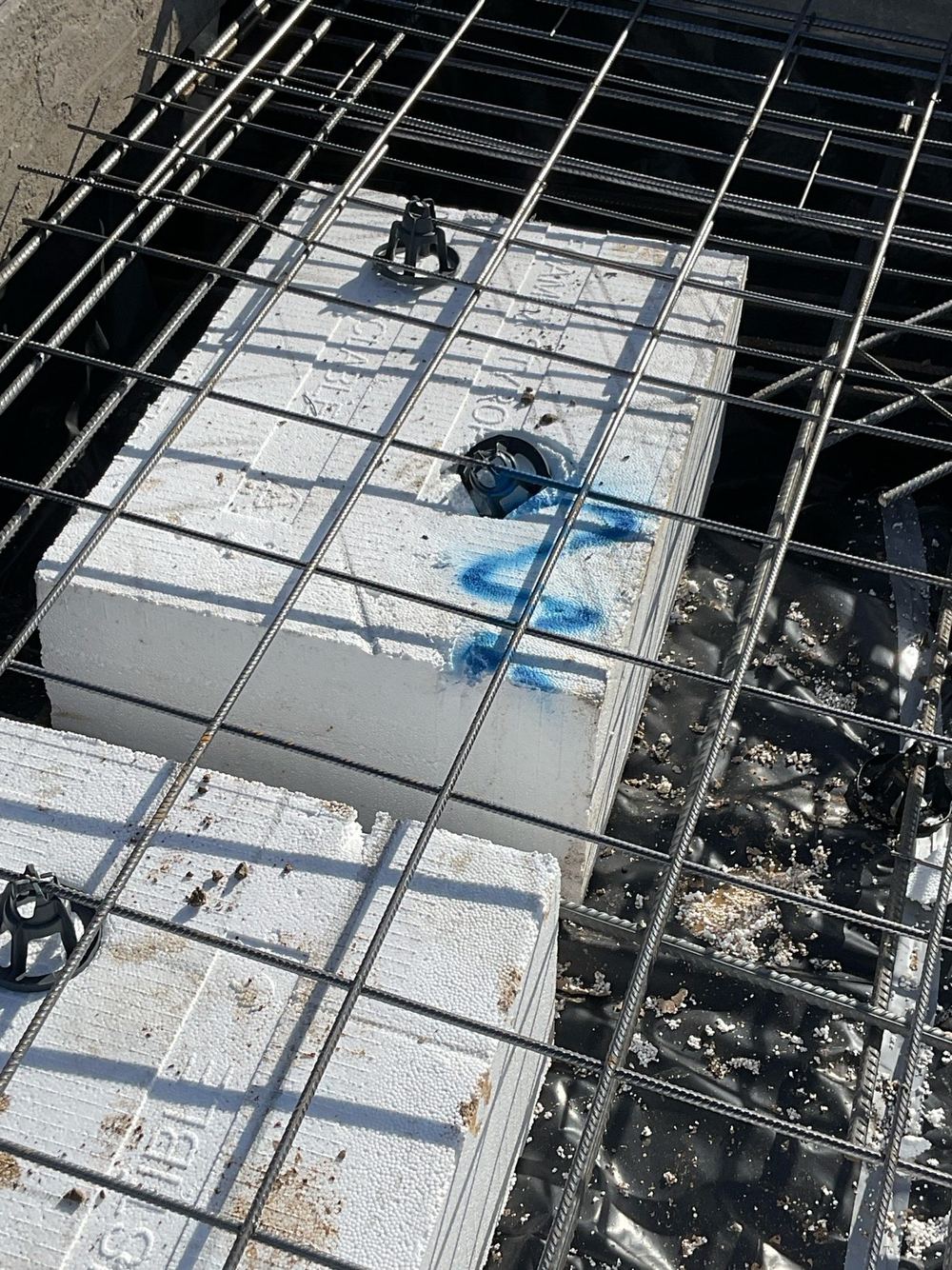 Reinforcement sitting on the ground with no bar chairs to lift it, found during a bored pier inspection in Tarneit