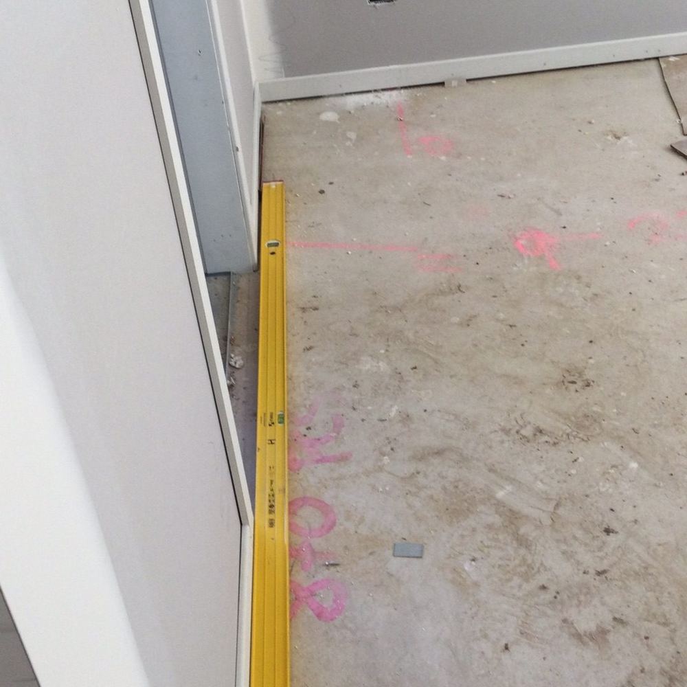 Bowed skirting boards visible along the wall line, found during a construction stage inspection in Tarneit