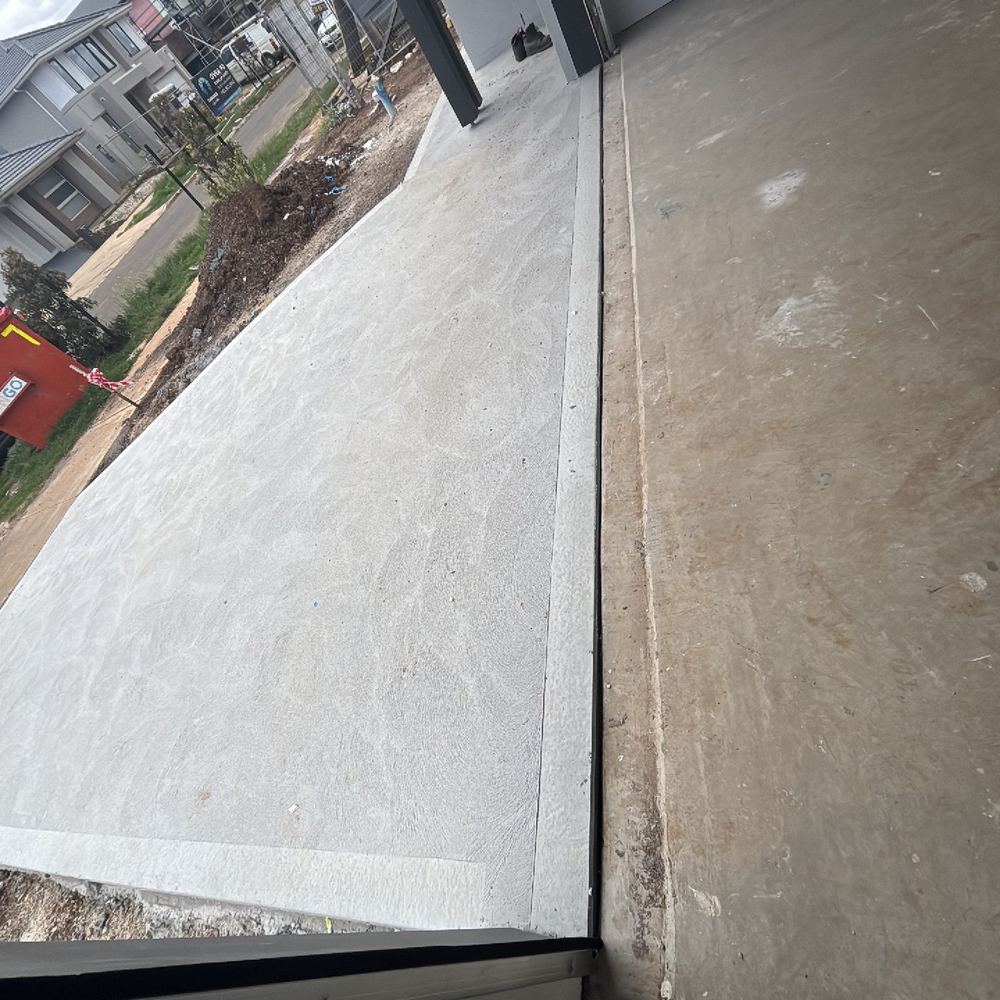 Slab to driveway joint left uncaulked, creating a water path under the slab, found during a building inspection in Tarneit