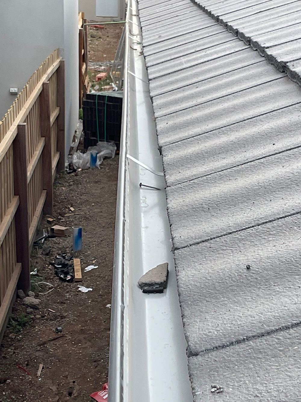 Debris left in the gutters that will wash into the downpipes, Tarneit