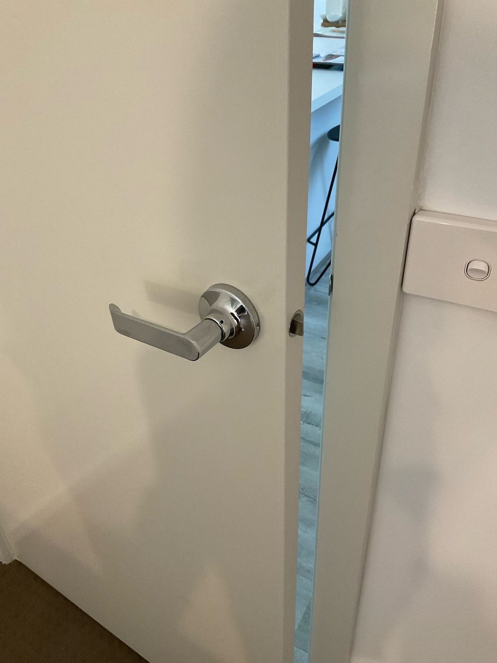 Door latch and strike plate out of alignment, found during a pre-purchase inspection in Truganina