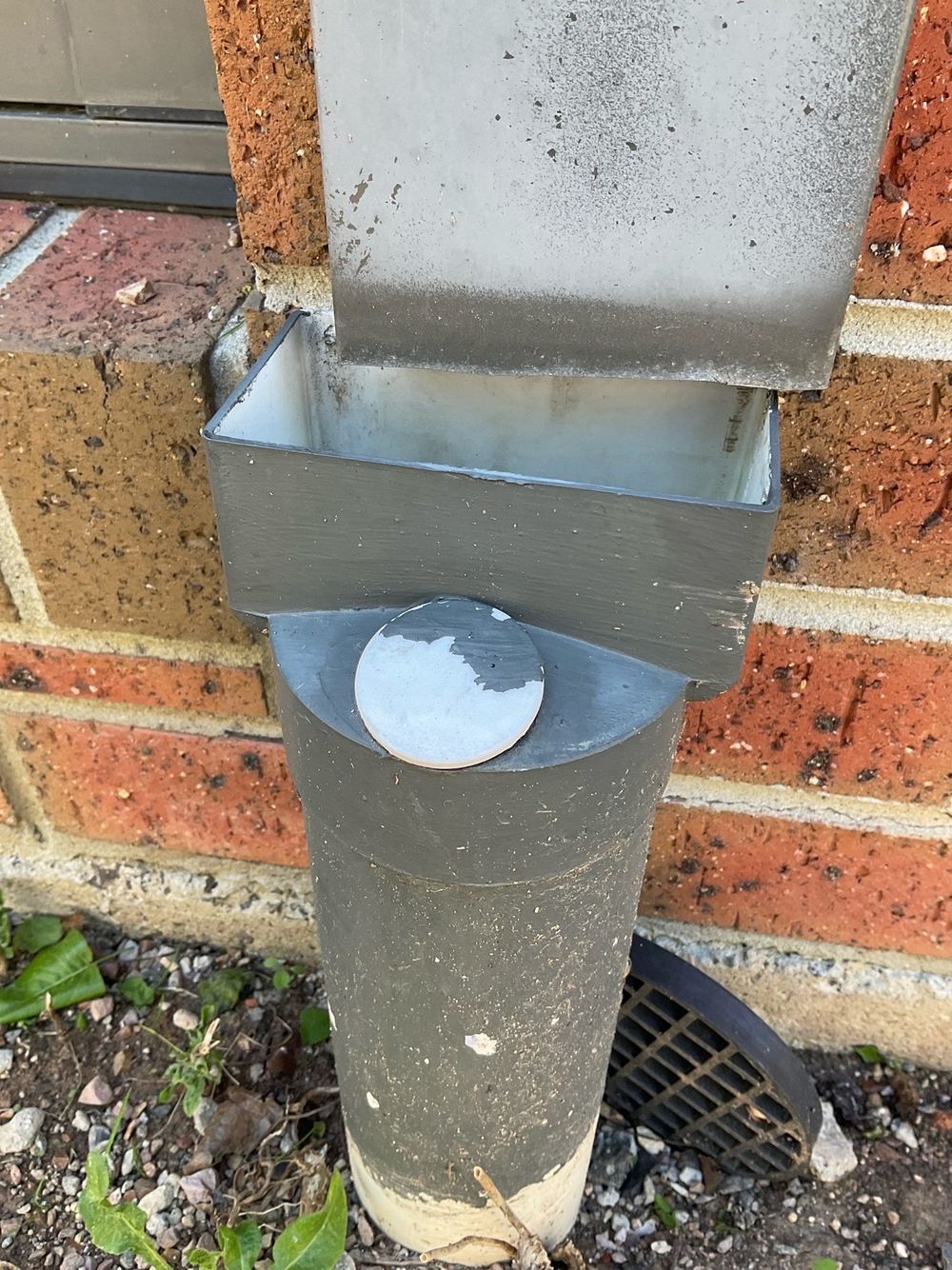 Downpipe discharging onto the ground instead of into drainage, found during a building and pest inspection in Point Cook